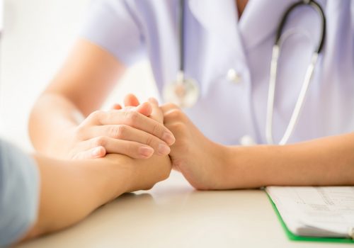 female psychologist consulting patient at the desk in hospital. Medicine and health care concept