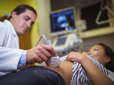 Female patient receiving a ultrasound scan on the stomach in hospital